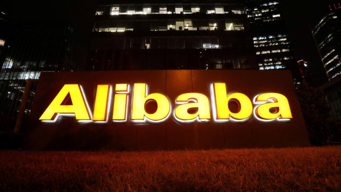 The logo of Alibaba Group is lit up at its office building in Beijing