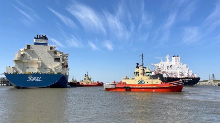 An LNG tanker is guided by tug boats at the Cheniere Sabine Pass export unit in Cameron Parish, Louisiana, US
