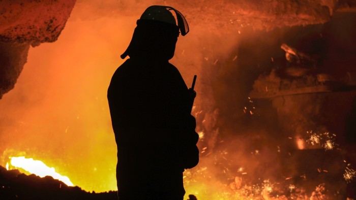 A steelworker watches as molten steel pours from one of the blast furnaces at British Steel’s Scunthorpe plant