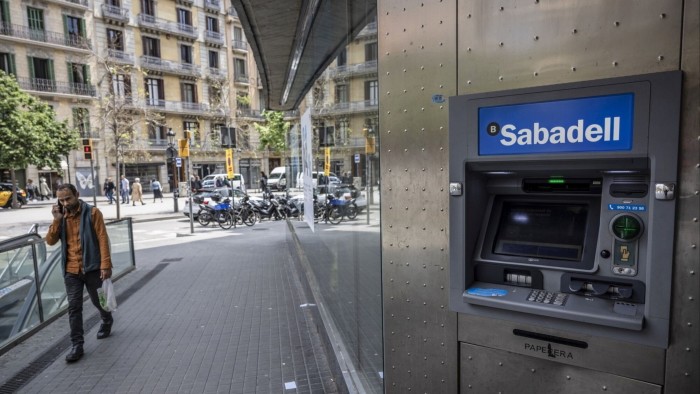 An automated teller machine (ATM) outside a Sabadell bank branch in Barcelona, Spain
