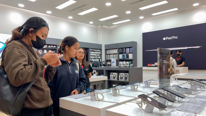 Customers in Indonesia look at iPhones inside a mall