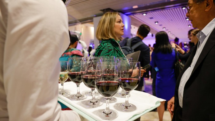 A waiter serves wine during the Welcome Reception ahead of the World Economic Forum (WEF) in Davos, Switzerland