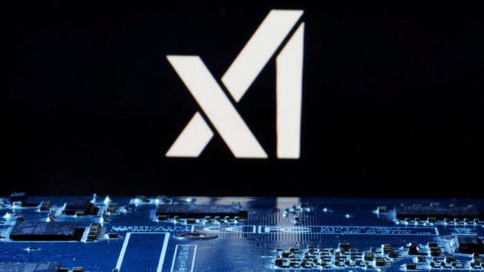 The xAI logo and a computer motherboard in the foreground