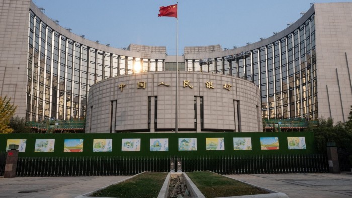 The People's Bank of China building in Beijing, with a Chinese flag flying above it