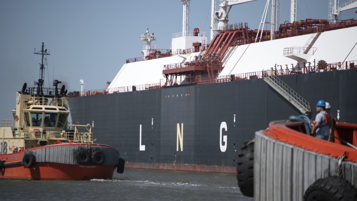 Tug boats prepare to pull out an LNG tanker from a  facility in Cameron, Louisiana