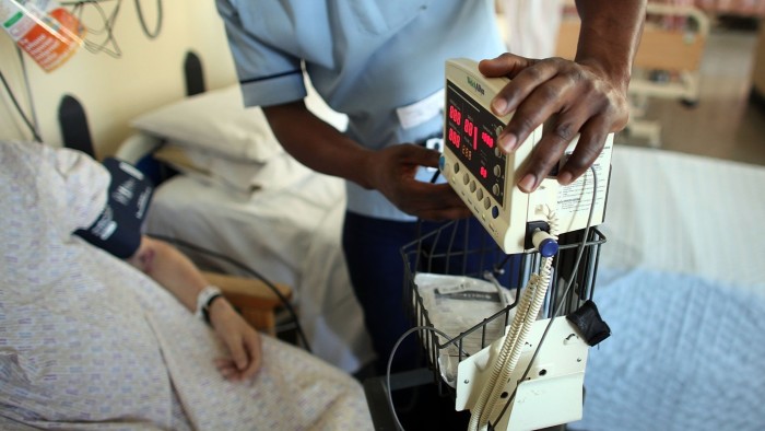 A nurse tends to a patient