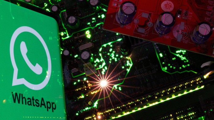 A montage of a smartphone displaying the  WhatsApp logo and a computer motherboard