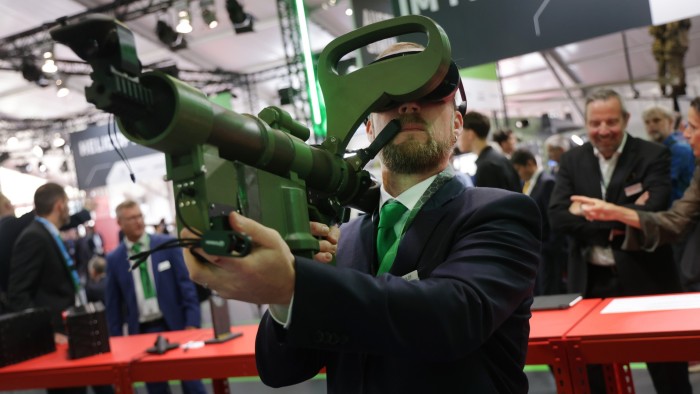 A host at Berlin Air Show demonstrates Hensoldt’s virtual reality trainer for anti-aircraft missiles in June 2024