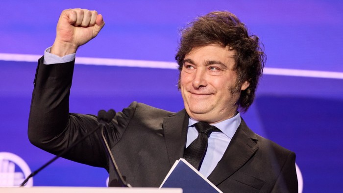 Javier Milei gestures by raising a clenched fist