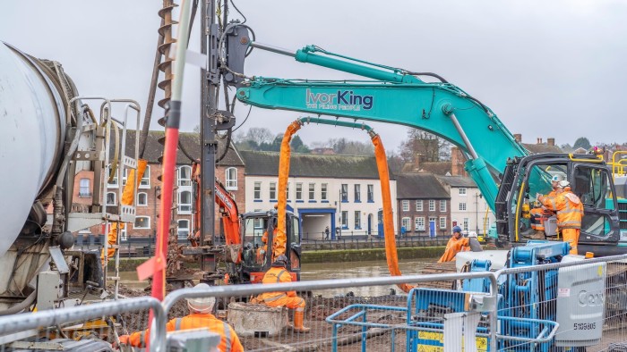 Contractors installing new River Severn flood defences on the Kidderminster side of the river in Bewdley in England in January 2024