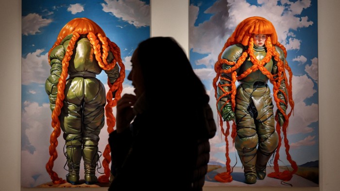 A visitor stands in front of Holly Herndon and Mat Dryhurst’s ‘Embedding Study 1’ and ‘Embedding Study 2’ at a preview for an AI-dedicated art sale at Christie’s in New York City, US on February 5 2025