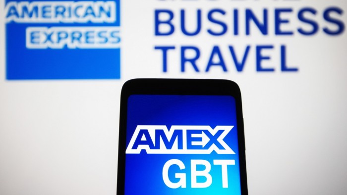 American Express Global Business Travel displayed on a smartphone and in the background
