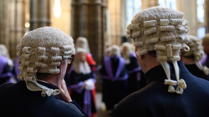 Two judges wait in Westminster Abbey, ahead of the annual service to mark the start of the legal year