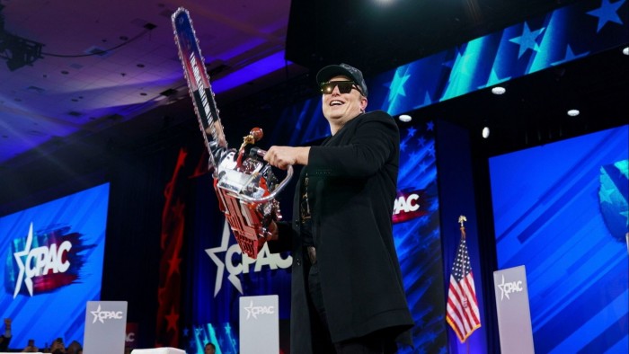 Elon Musk holds a chainsaw that was given by Argentina’s President Javier Milei at a conference in Maryland, US on Thursday