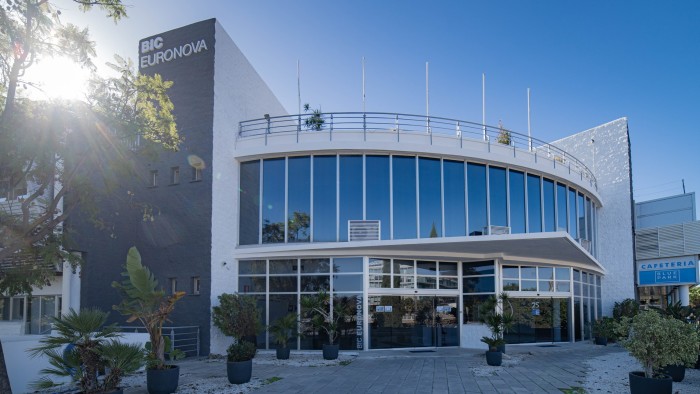 A modern, curved glass-front building with the sign “BIC Euronova” on its exterior