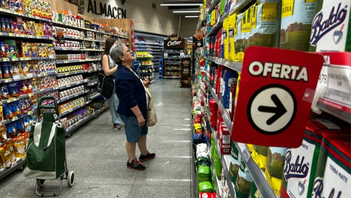 Women buy groceries at a supermarket in Buenos Aires, Argentina