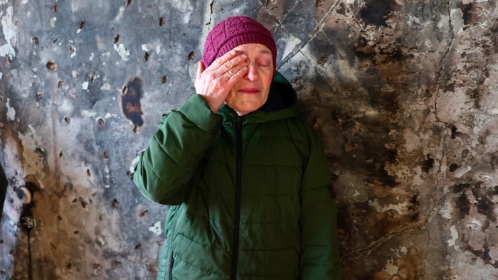 Nadia, 69, cries inside her burned apartment of a multi-storey building damaged by a Russian drone strike on a residential neighbourhood in Zaporizhzhia