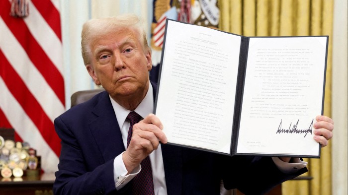 Donald Trump holds a signed executive order
