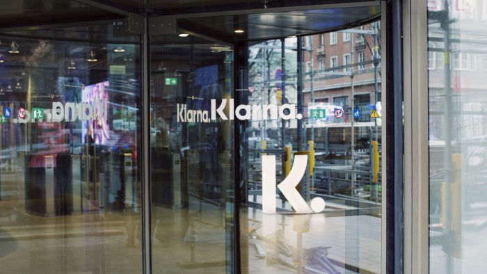 The Klarna logo on revolving doors at the entrance to the company’s headquarters in Stockholm, Sweden