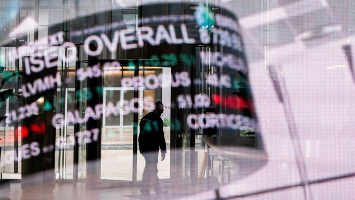 The reflection of a digital board showing trading data at the Euronext NV stock exchange in the La Défense business district in Paris, France