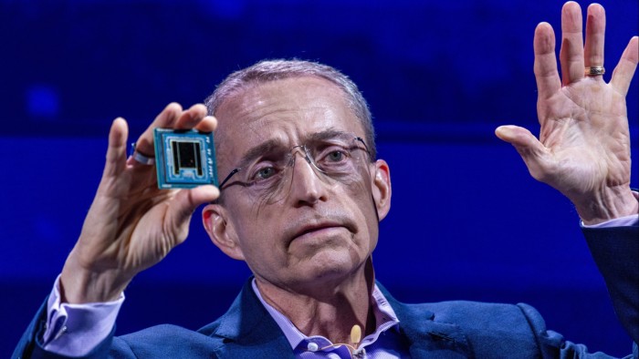 Pat Gelsinger, chief executive officer of Intel, holds an AI processor up during a conference