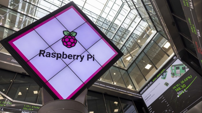 The Raspberry Pi logo is displayed on a digital screen inside the London Stock Exchange