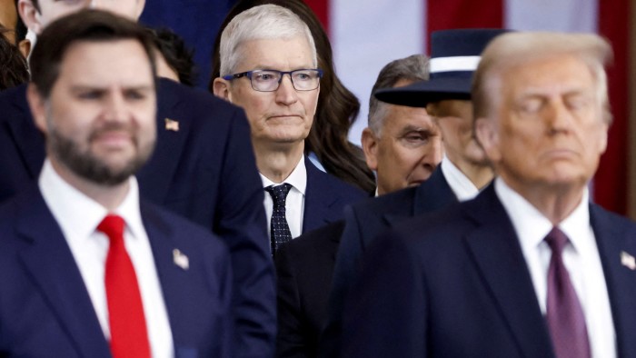 Apple CEO Tim Cook is seen behind US President Donald Trump and US vice-president JD Vance