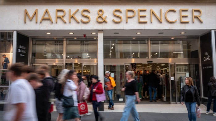 Shoppers pass a branch of Marks and Spencer in Bath