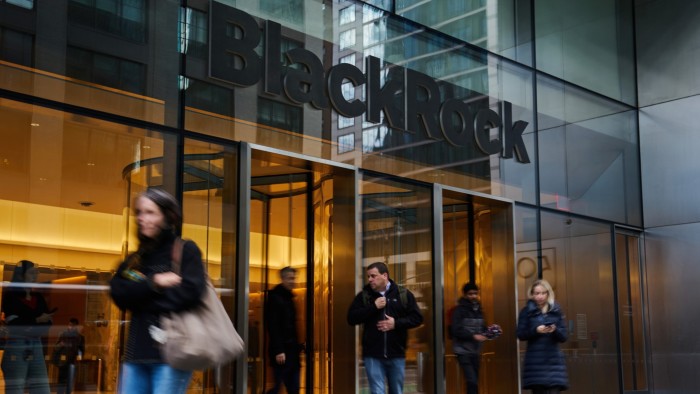 People walk past the entrance of BlackRock headquarters in New York City