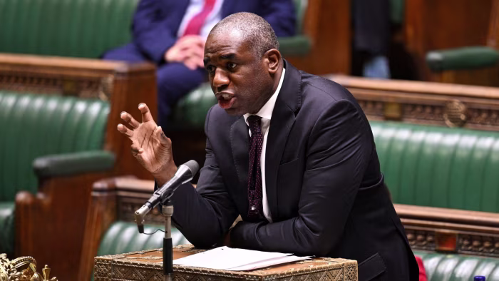 David Lammy speaks during a parliamentary session, gesturing with his hand.