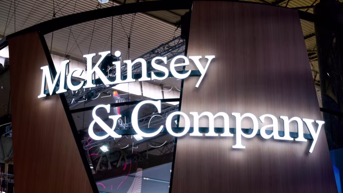 The McKinsey & Company logo at an exhibition stand.