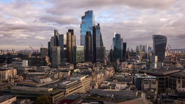 City of London skyline featuring modern skyscrapers and commercial buildings under a cloudy sky.