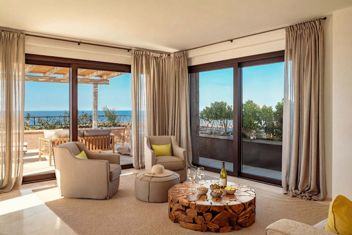 Il soggiorno di un appartamento con tre letti in giardino a La Tiara